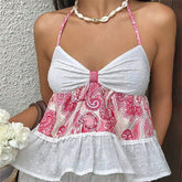 White and pink patterned dress worn by a person against a neutral background